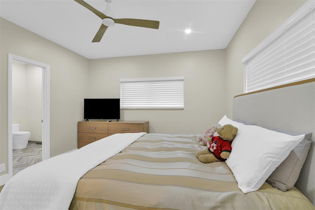 319 South Riverside Drive Pompano Beach, FL 33062 - Photo 52 of 88 a bedroom with a bed and a tv