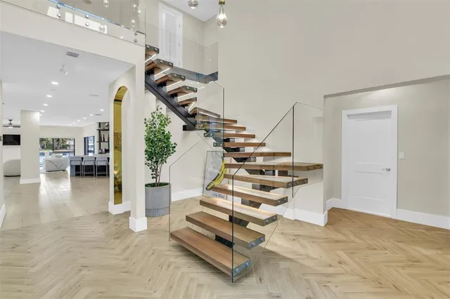 a view of a kitchen with kitchen island stainless steel appliances a sink and counter top space