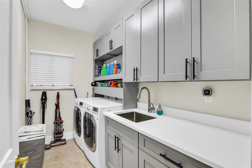 319 South Riverside Drive Pompano Beach, FL 33062 - Photo 88 of 88 a kitchen with a sink a stove and cabinets