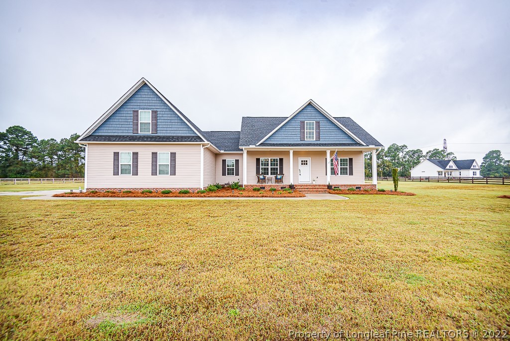 5641 Wade-Stedman Road Wade, NC 28395 - Photo 1 of 46 a front view of a house with swimming pool having outdoor seating