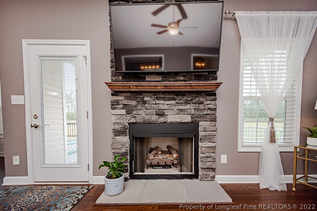 5641 Wade-Stedman Road Wade, NC 28395 - Photo 17 of 46 a living room with a fireplace and a window