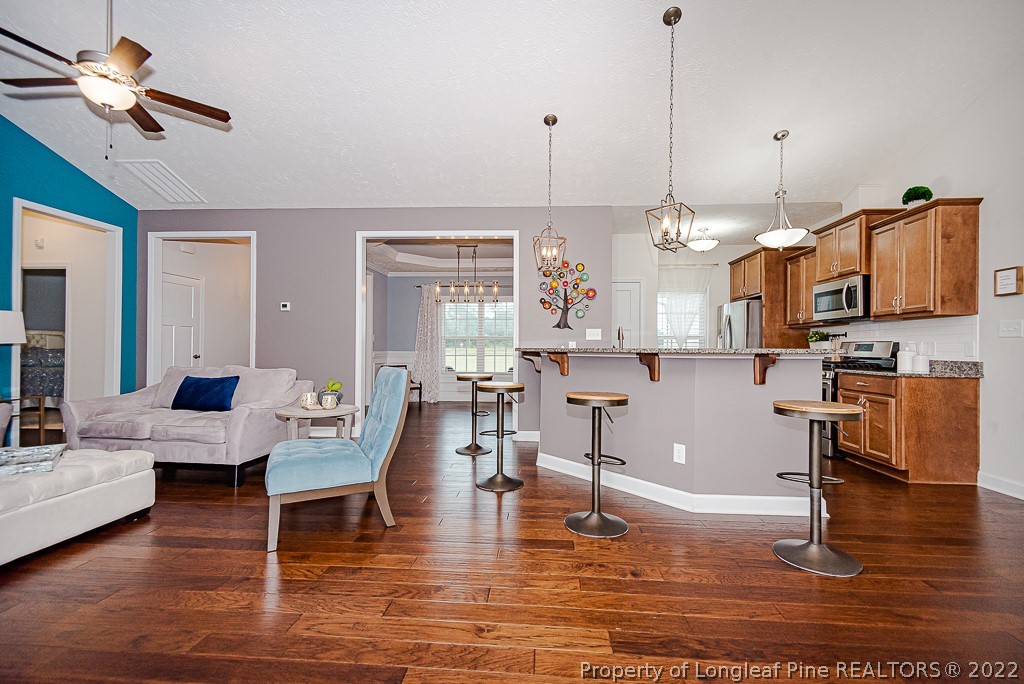 5641 Wade-Stedman Road Wade, NC 28395 - Photo 25 of 46 a living room with fireplace furniture and a wooden floor