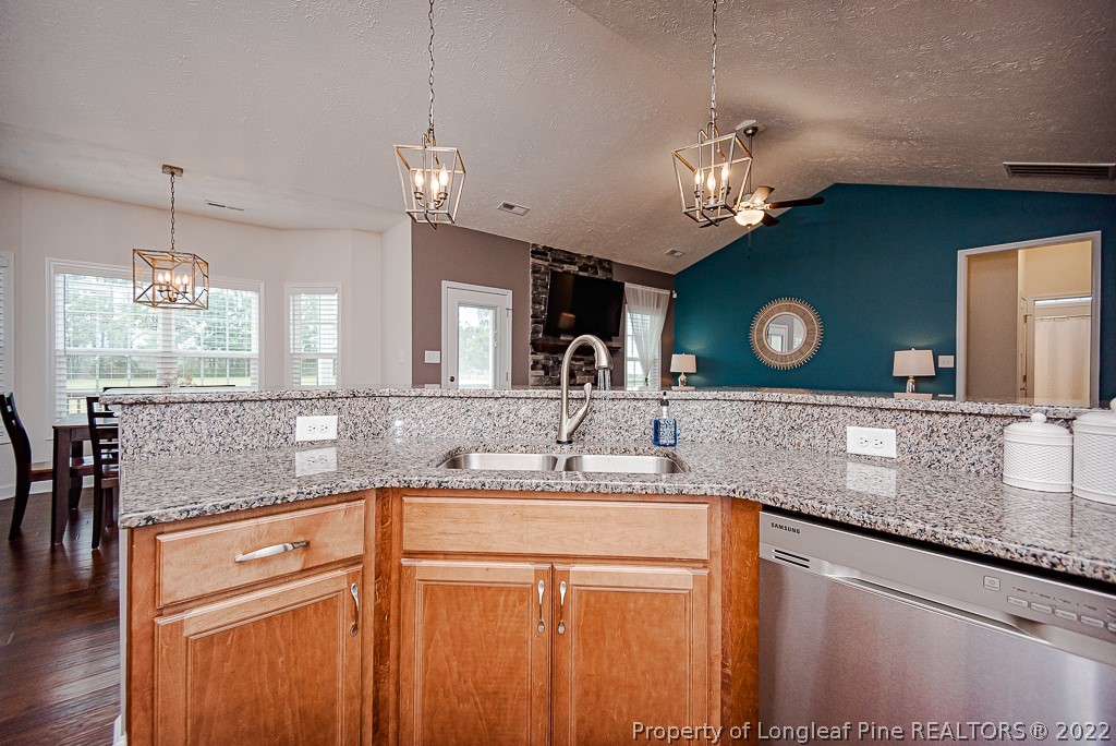 5641 Wade-Stedman Road Wade, NC 28395 - Photo 28 of 46 a kitchen with a sink a center island and cabinets