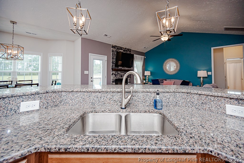 5641 Wade-Stedman Road Wade, NC 28395 - Photo 29 of 46 a bathroom with a granite countertop sink a large mirror and vanity