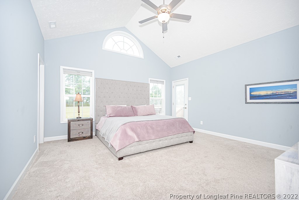 5641 Wade-Stedman Road Wade, NC 28395 - Photo 35 of 46 a spacious bedroom with a bed and a chandelier