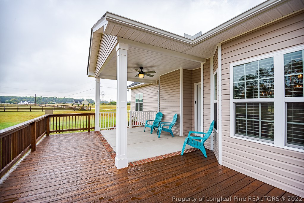 5641 Wade-Stedman Road Wade, NC 28395 - Photo 8 of 46 a balcony with wooden floor table and chairs