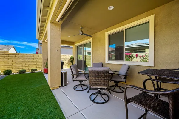 a bedroom with a bed and a flat tv screen on dresser