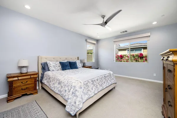 a spacious bathroom with a double vanity sink and mirror