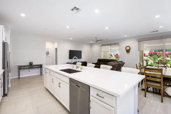 a dining room with furniture and a floor to ceiling window