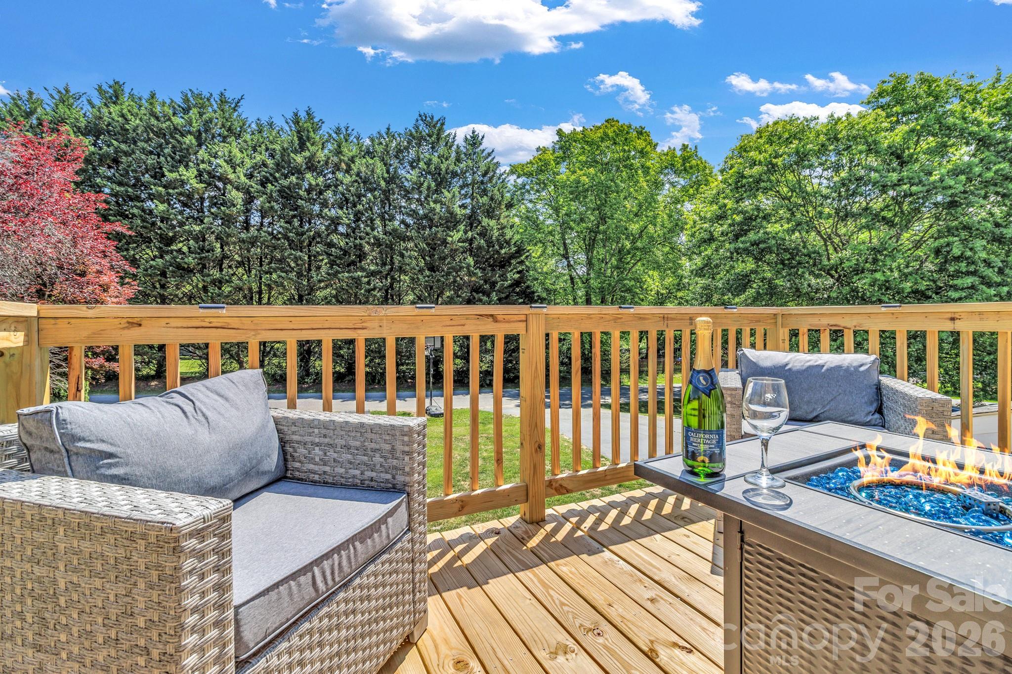 13 Spring Lake Drive Fletcher, NC 28732 - Photo 6 of 30 a view of a deck with table and chairs with wooden floor and fence
