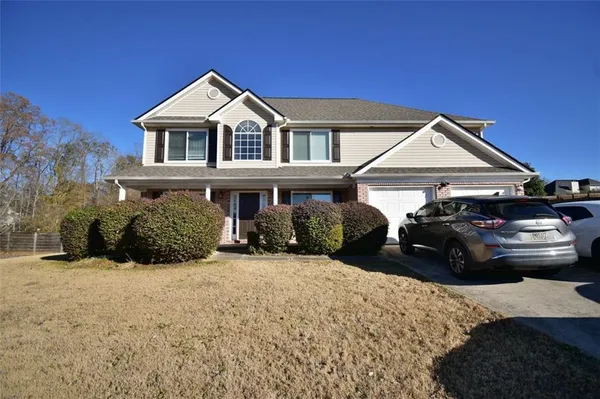 a front view of a house with a yard