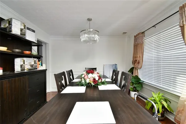 a view of a dining room with furniture wooden floor and a rug
