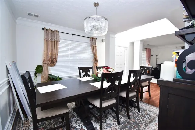 a view of a dining room with furniture and chandelier