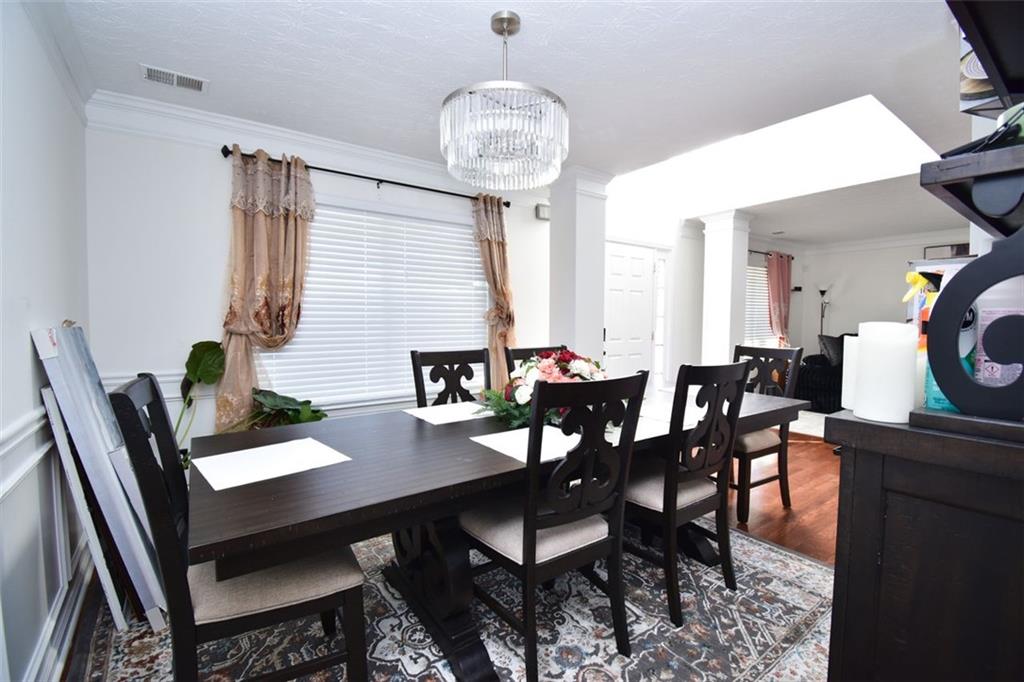 12140 Dominion Drive Hampton, GA 30228 - Photo 12 of 52 a view of a dining room with furniture and chandelier