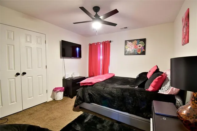 a bedroom with a bed and a flat screen tv