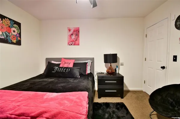 a bathroom with a sink a toilet and shower curtain