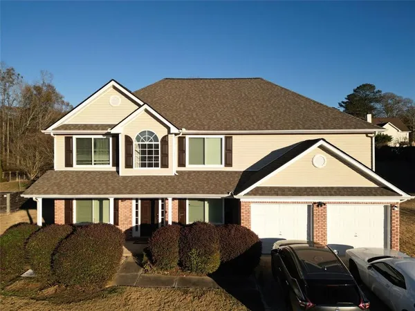 a front view of a house with a yard