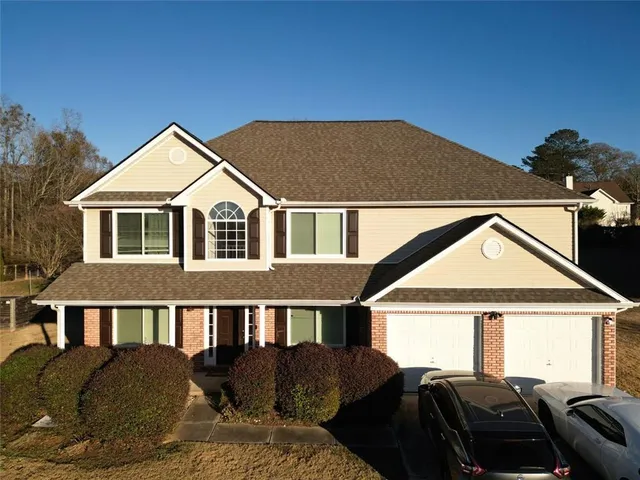a front view of a house with a yard