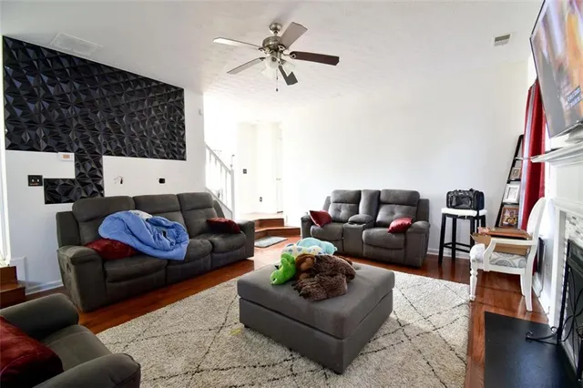 a living room with furniture and wooden floor