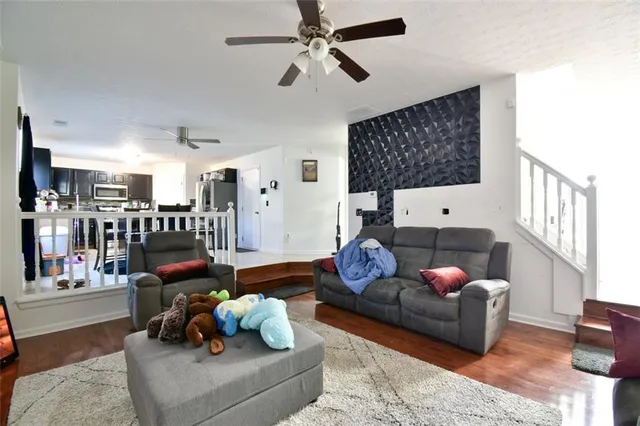 a dining area with stainless steel appliances kitchen island granite countertop a dining table and chairs