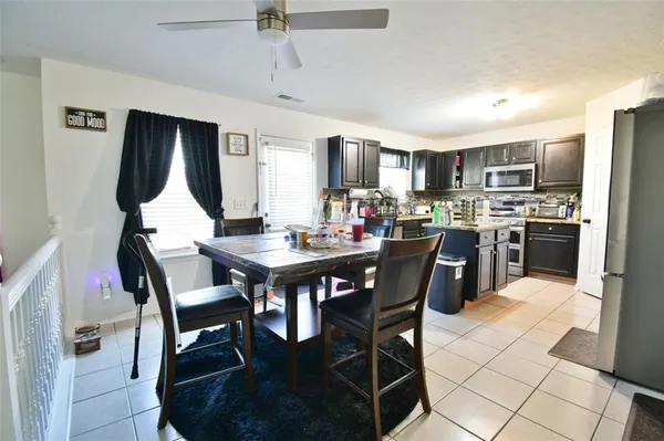 a kitchen view with a refrigerator stove and oven