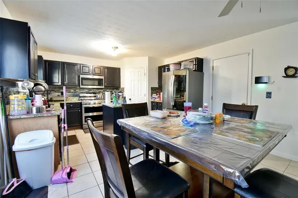 a kitchen with granite countertop lots of counter top space dining table and chairs