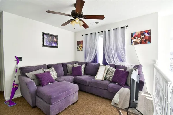 a living room with furniture and a large window