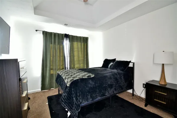 a bedroom with a bed and window