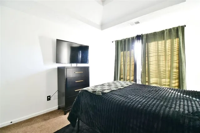 a bedroom with a bed and a cabinets