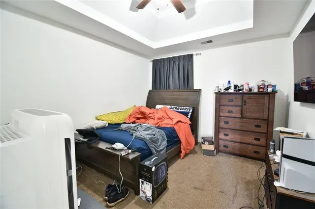 a bedroom with furniture and a chandelier