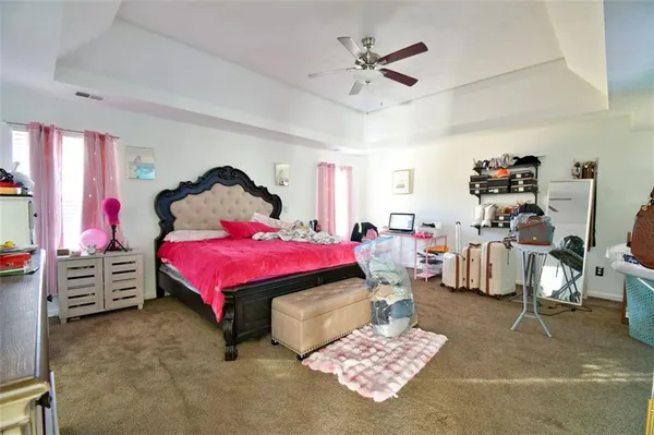 a bedroom with a bed and a view of kitchen