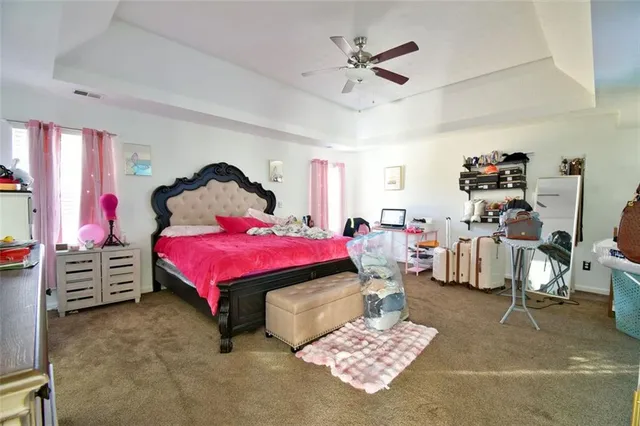 a bedroom with a bed and a view of kitchen
