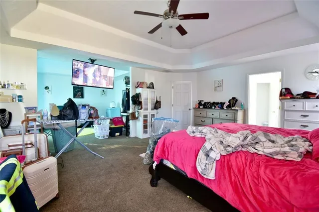 a bedroom with bed and a wooden floor