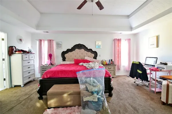 a bedroom with bed and a tv