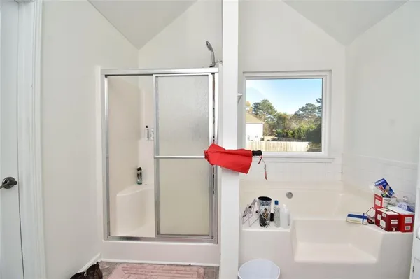 a white toilet sitting next to a white sink and vanity