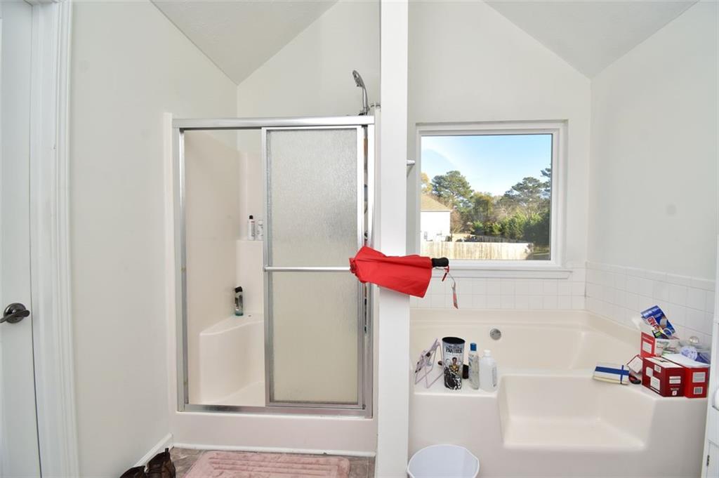 12140 Dominion Drive Hampton, GA 30228 - Photo 48 of 52 a bathroom with a tub and a shower curtain
