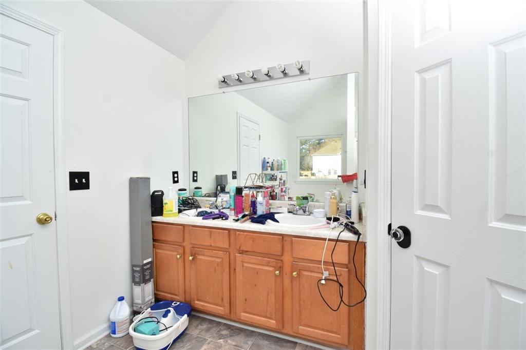 12140 Dominion Drive Hampton, GA 30228 - Photo 49 of 52 a bathroom with a sink and a mirror
