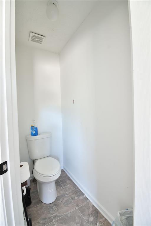 12140 Dominion Drive Hampton, GA 30228 - Photo 50 of 52 a white toilet sitting next to a white sink and vanity
