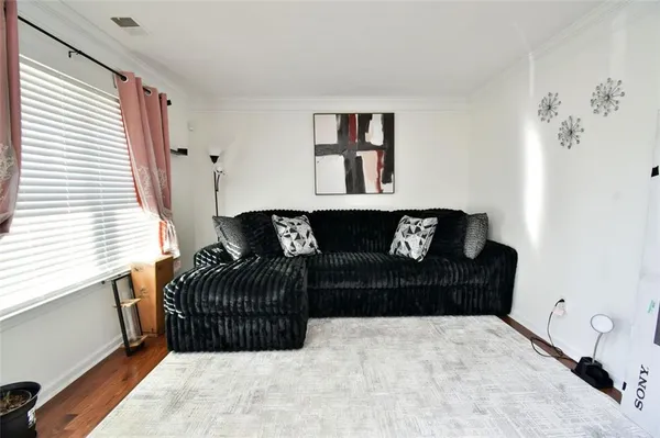 a living room with furniture a piano and a window