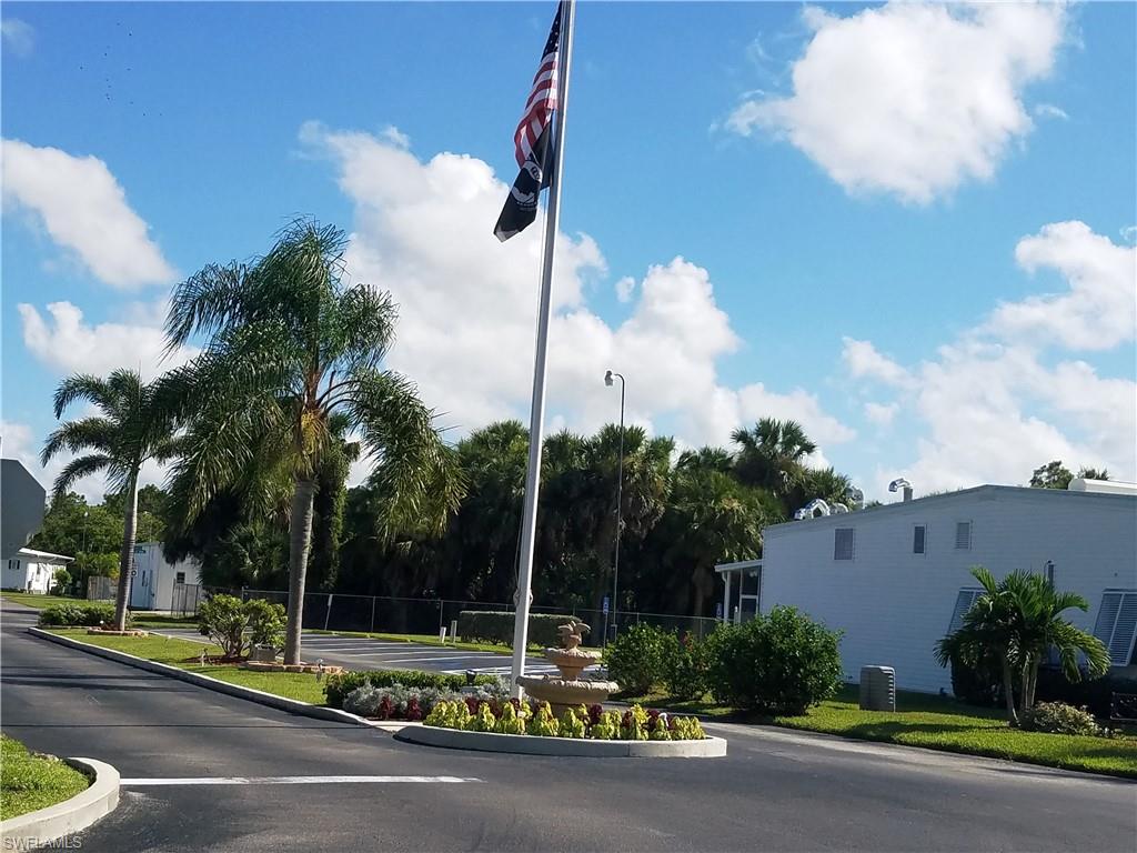 7 Jasper Drive Naples, FL 34114 - Photo 1 of 4 a view of a street with a building in the background