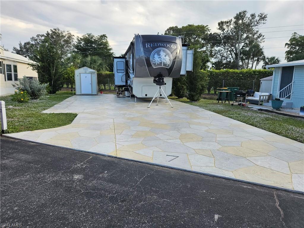 7 Jasper Drive Naples, FL 34114 - Photo 2 of 4 a view of a backyard with sitting area