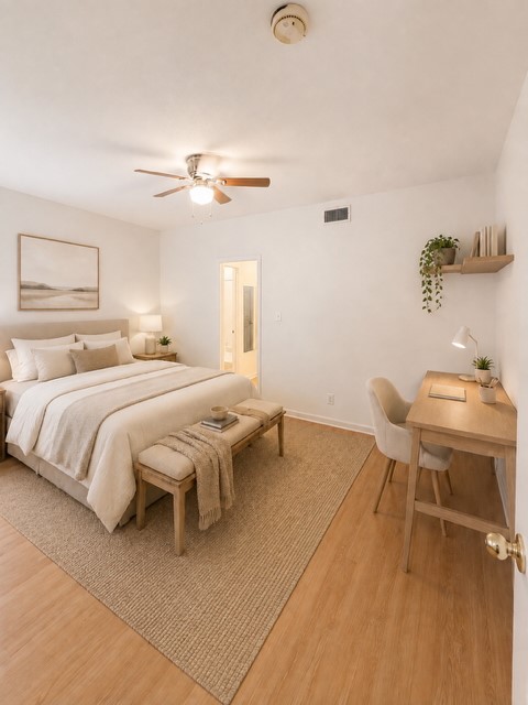 2529 Rio Grande Street, Unit 78 Austin, TX 78705 - Photo 1 of 14 A tranquil sleeping space features a ceiling fan, light wood floors, and a dedicated workspace.