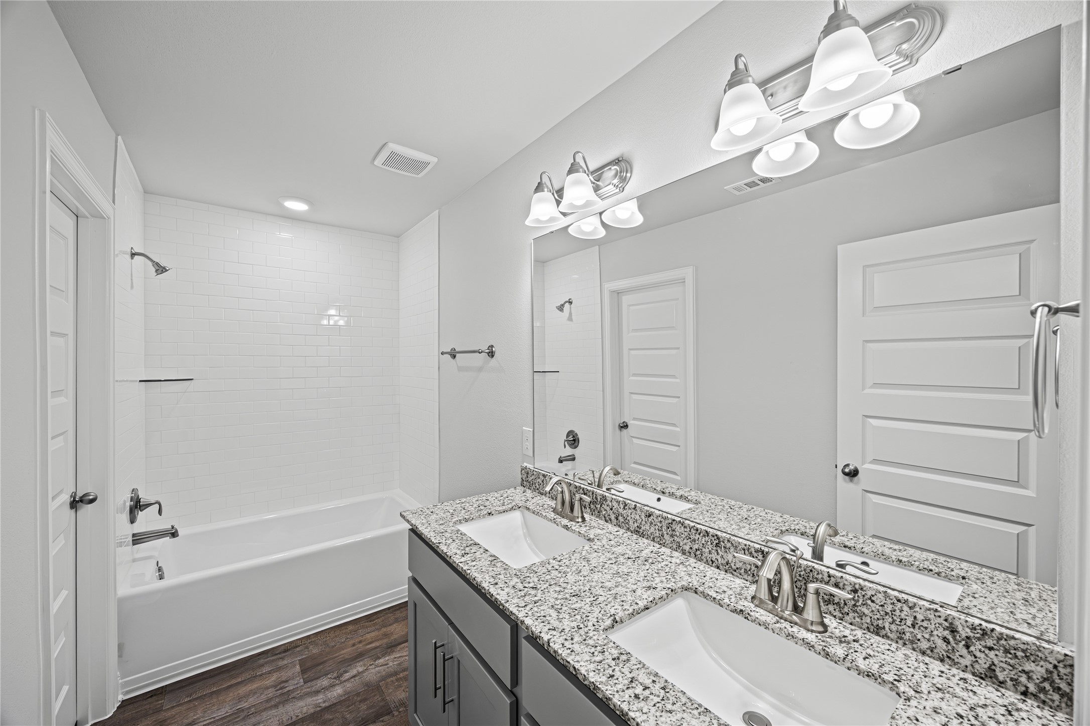9460 Hard Rock Road Conroe, TX 77303 - Photo 15 of 17 a bathroom with a granite countertop sink a mirror and a bathtub