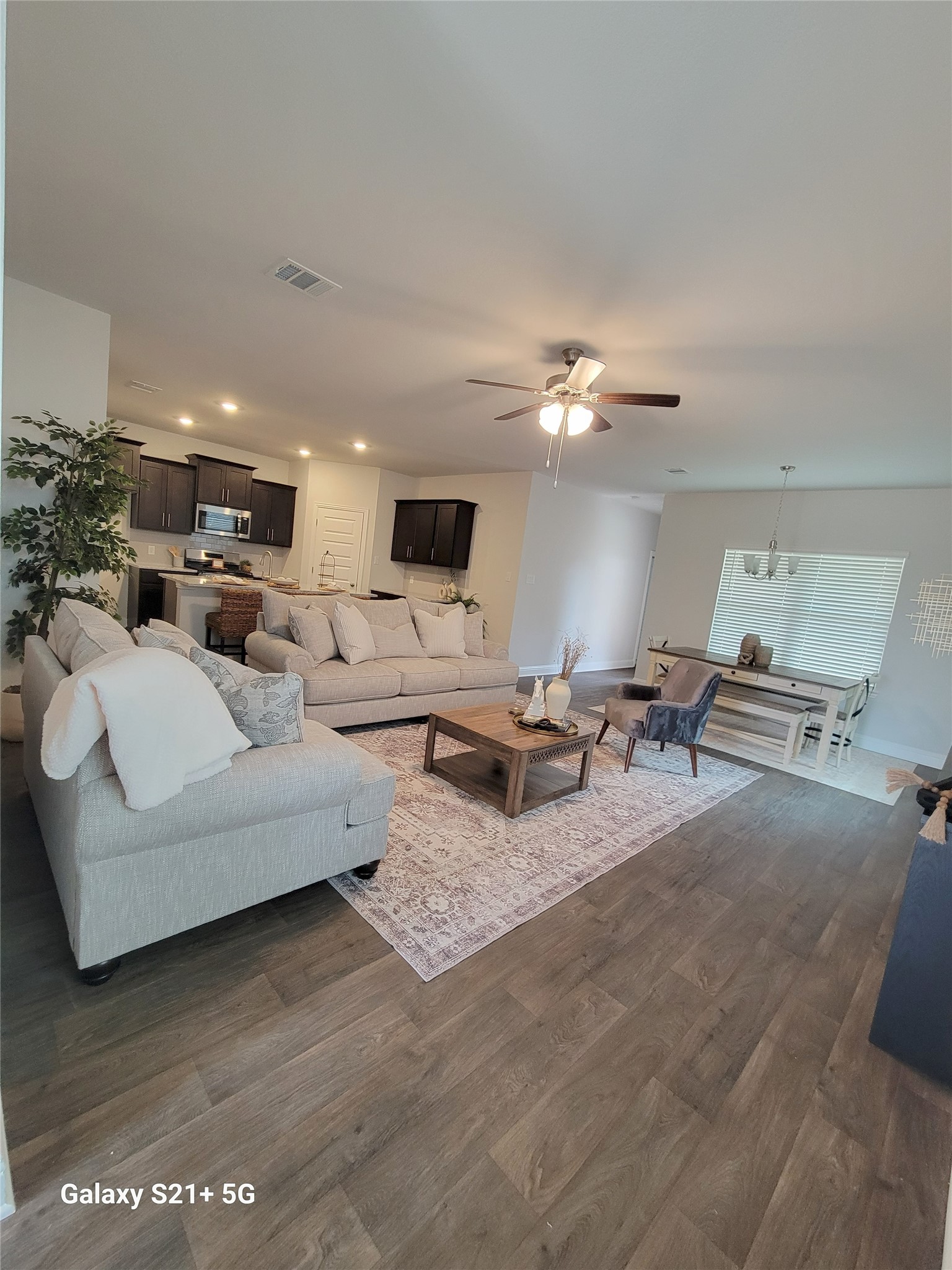9460 Hard Rock Road Conroe, TX 77303 - Photo 6 of 17 a living room with furniture and a chandelier