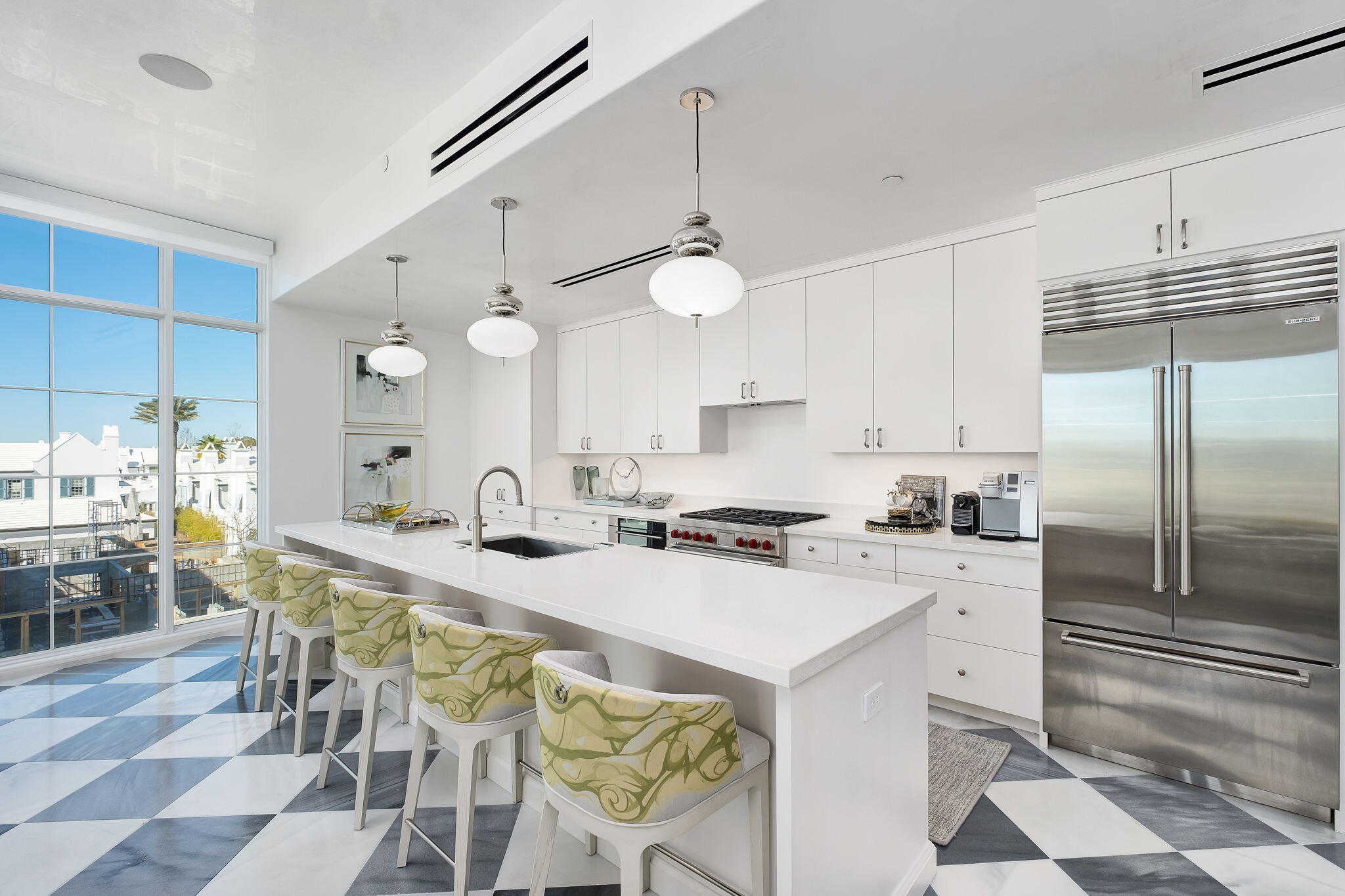 27 Admiralty Row, Unit 302 Alys Beach, FL 32461 - Photo 6 of 33 a kitchen with a dining table chairs sink and white cabinets