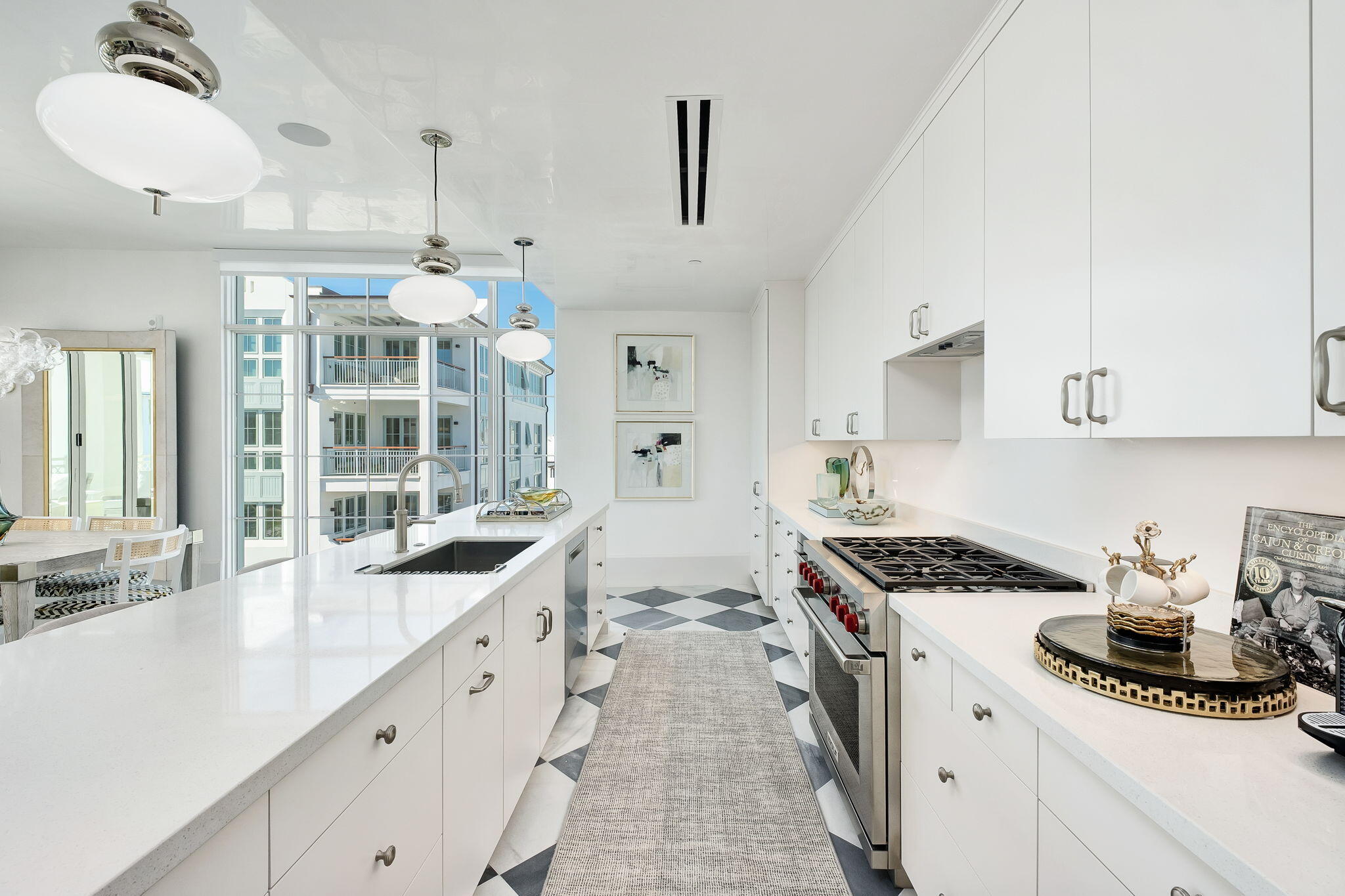 27 Admiralty Row, Unit 302 Alys Beach, FL 32461 - Photo 7 of 33 a large white kitchen with stainless steel appliances granite countertop a stove and a sink