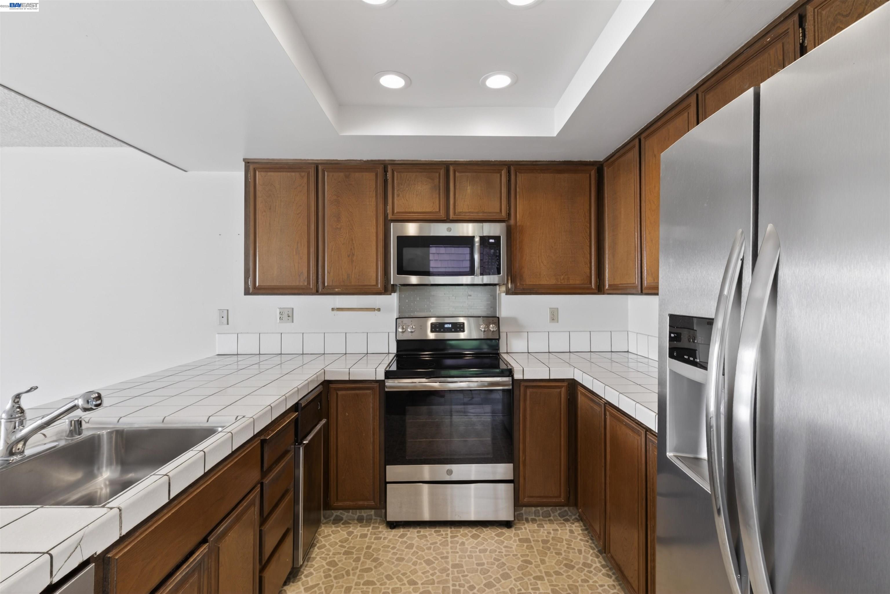 202 Baywood Road Alameda, CA 94502 - Photo 13 of 26 a kitchen with a sink and stainless steel appliances