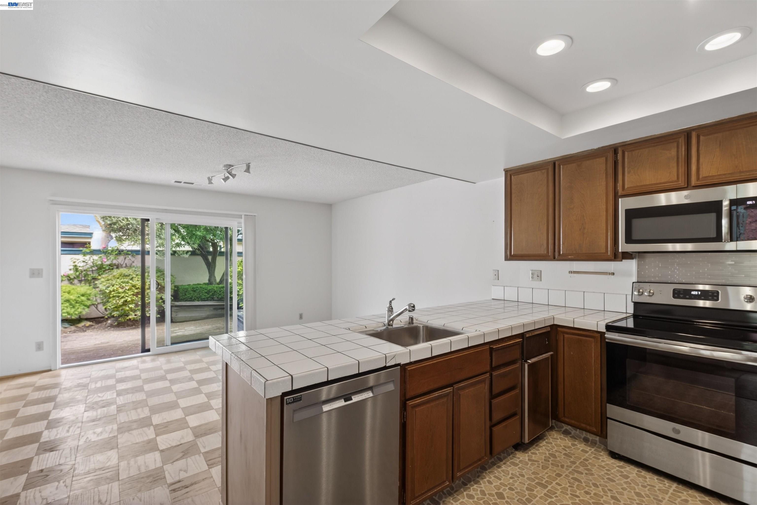 202 Baywood Road Alameda, CA 94502 - Photo 14 of 26 a kitchen with a sink stove and microwave