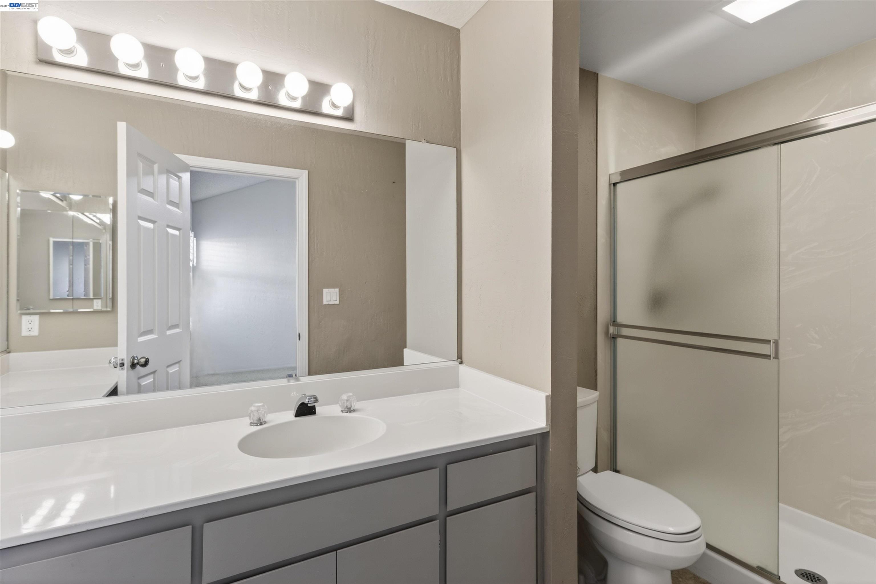 202 Baywood Road Alameda, CA 94502 - Photo 22 of 26 a bathroom with a sink a toilet a mirror and shower