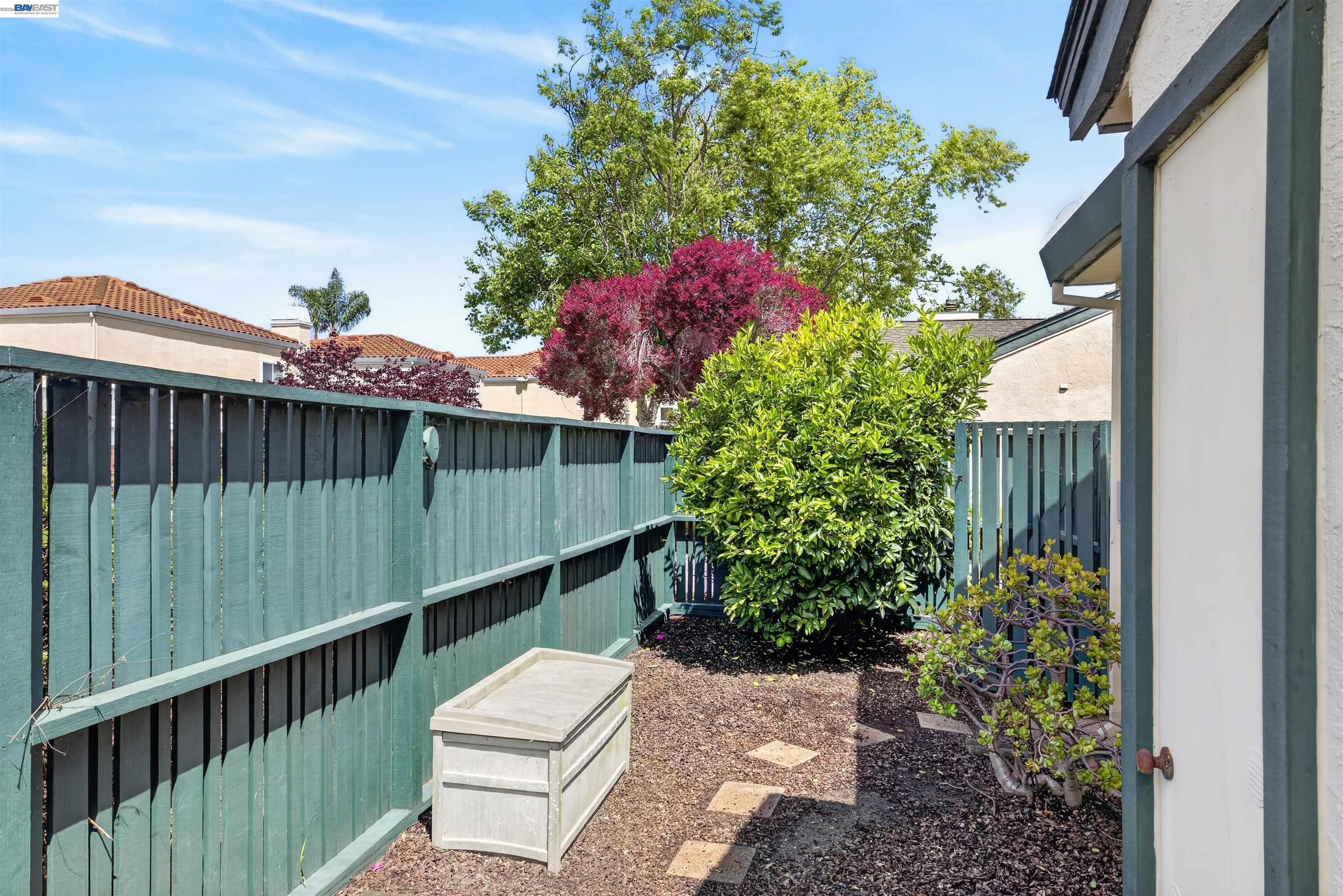 202 Baywood Road Alameda, CA 94502 - Photo 25 of 26 a view of a backyard with a small deck and a flower garden